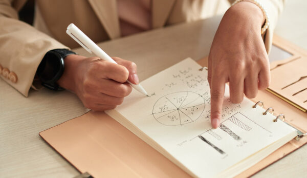 businesswoman-writing-plans-in-notebook-2025-01-31-00-48-55-utc