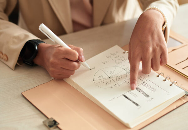 businesswoman-writing-plans-in-notebook-2025-01-31-00-48-55-utc