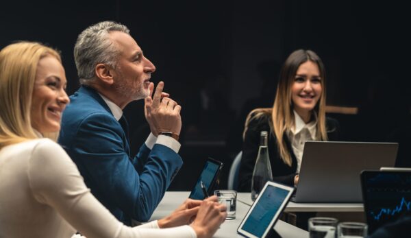 The group of people sitting at the table on business conference