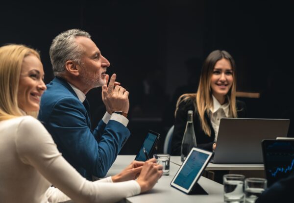 The group of people sitting at the table on business conference